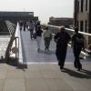 People walking across bridge.